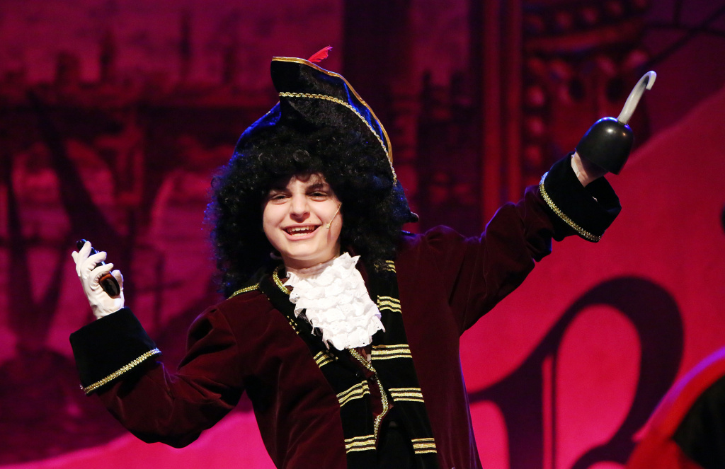 An actor in costume on stage.