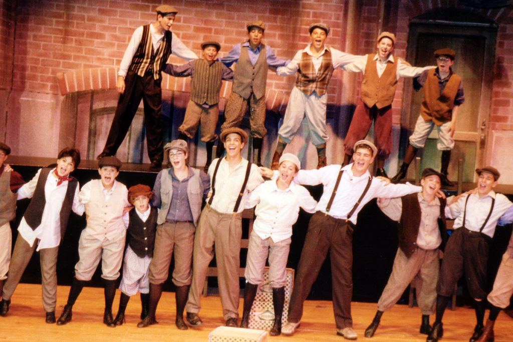 Cast members on stage during a performance