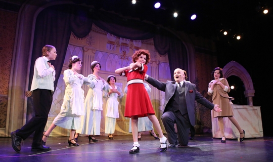 Actors on stage in Annie Jr costumes