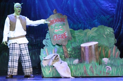 An actor in a Shrek Jr costume