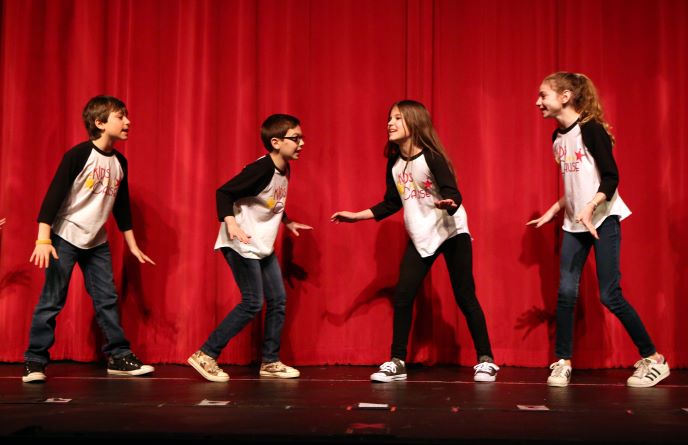 Kids acting on stage.
