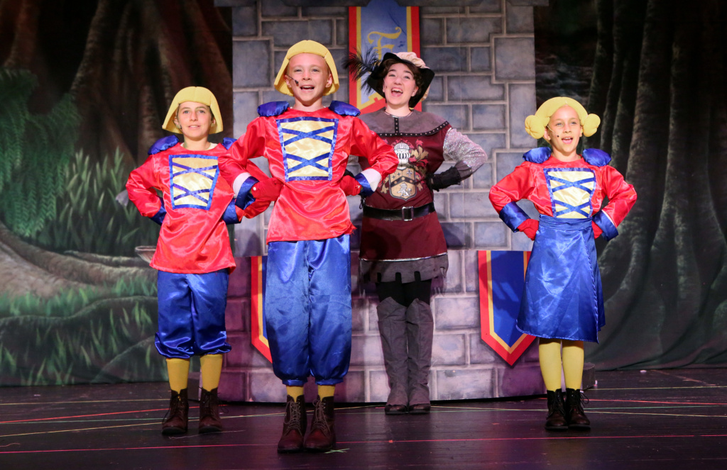 Cast members performing on stage