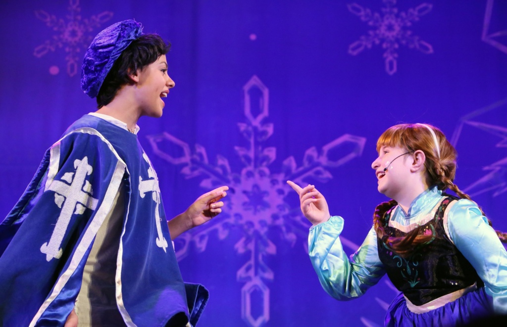 Cast members performing on stage.