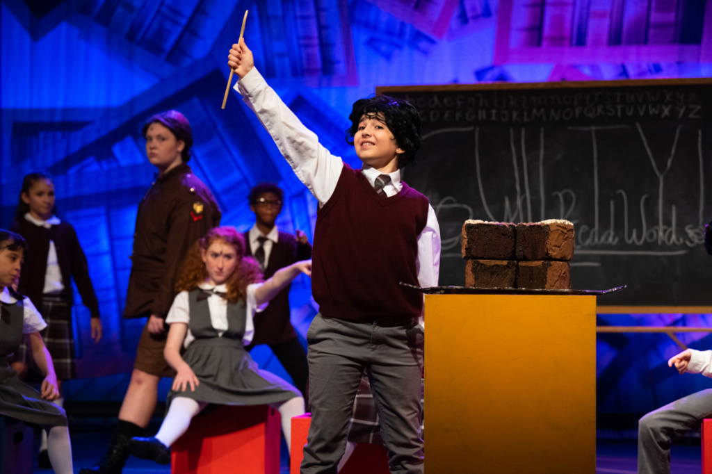 Cast members of Matilda on stage.